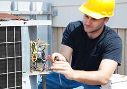 photo of contractor repairing ac unit