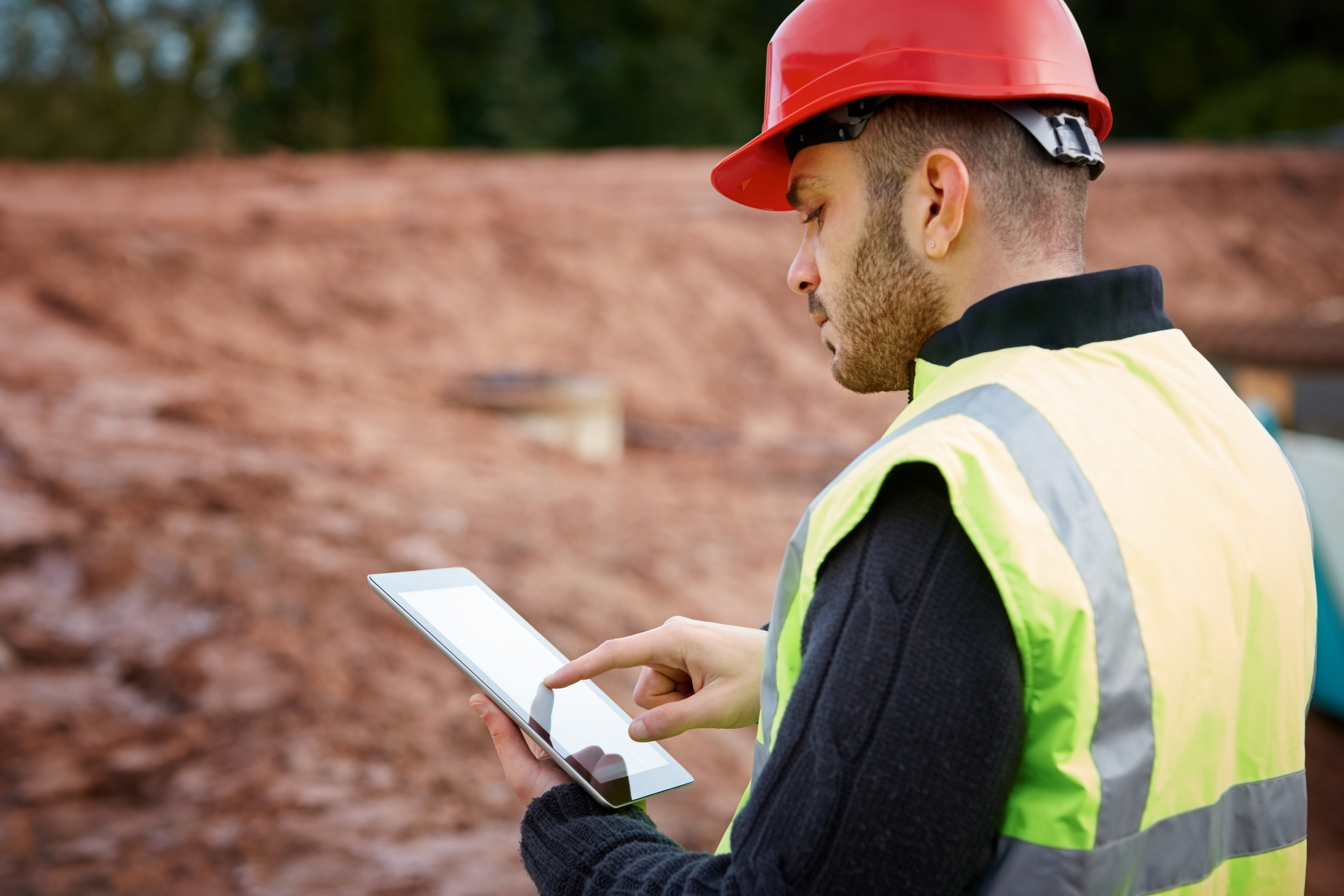 photo of a contractor working out in the field and using a tablet